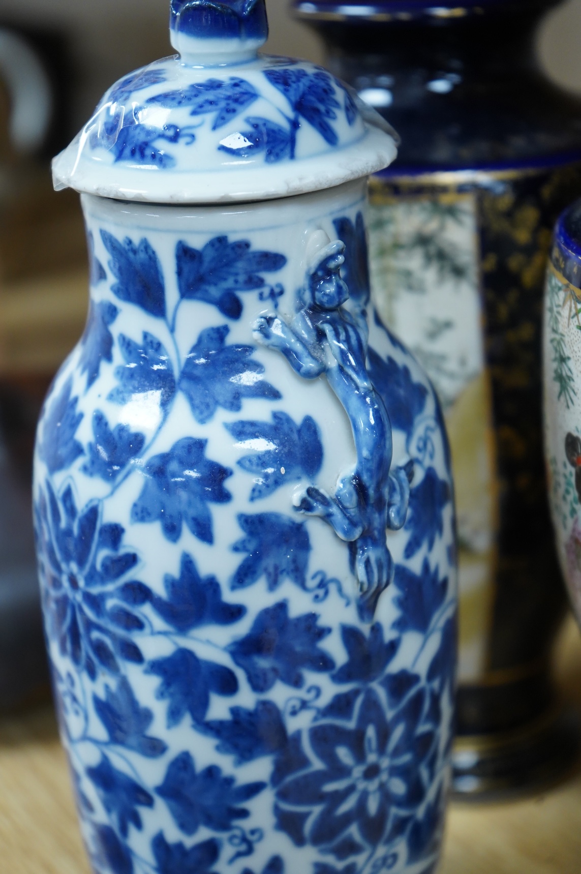 A late 19th century Chinese blue and white vase and cover and two Japanese Satsuma pottery vases, largest 24cm high